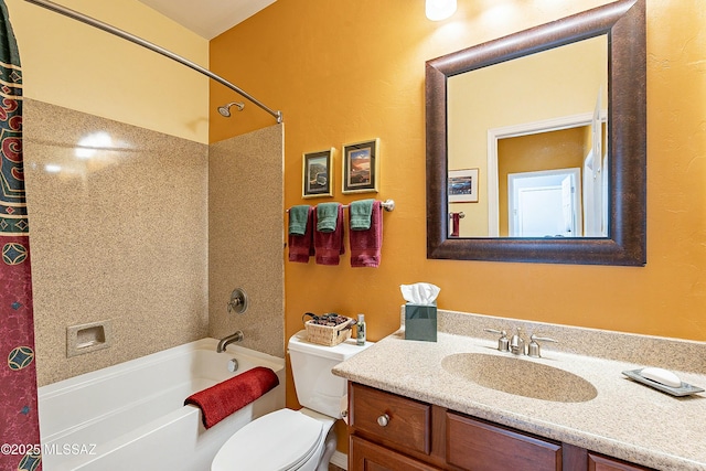 bathroom featuring vanity, shower / bathing tub combination, and toilet