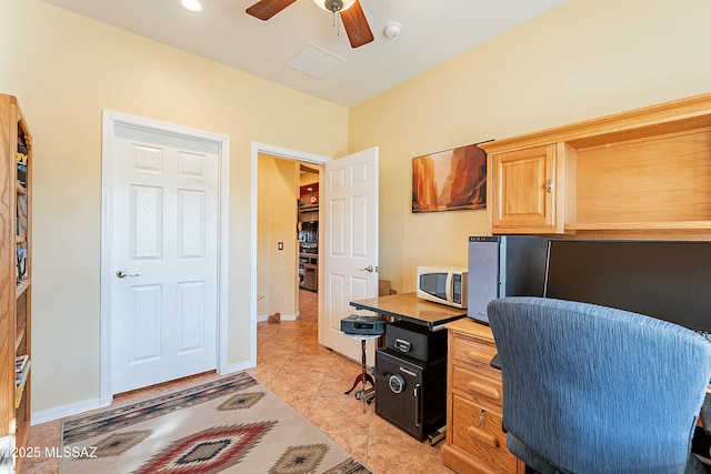 office area featuring light tile patterned floors, visible vents, baseboards, and a ceiling fan