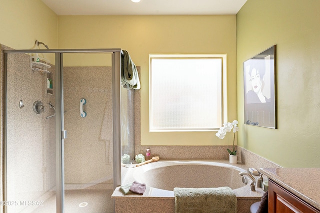 full bath featuring vanity, a garden tub, and a shower stall