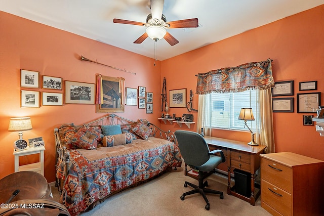 bedroom featuring a ceiling fan and carpet