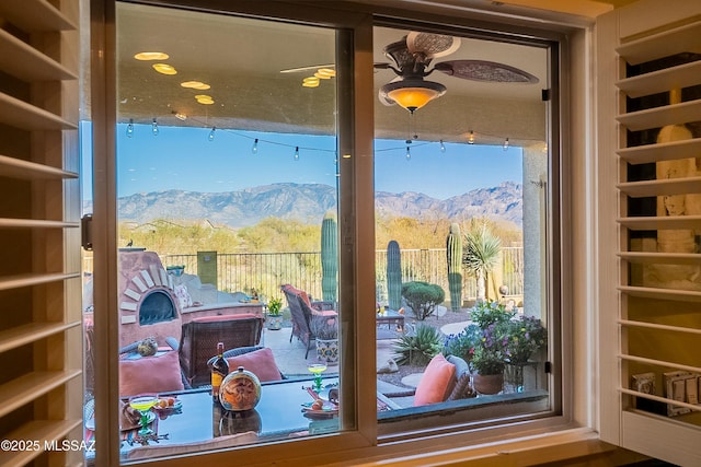 details with a ceiling fan and a mountain view