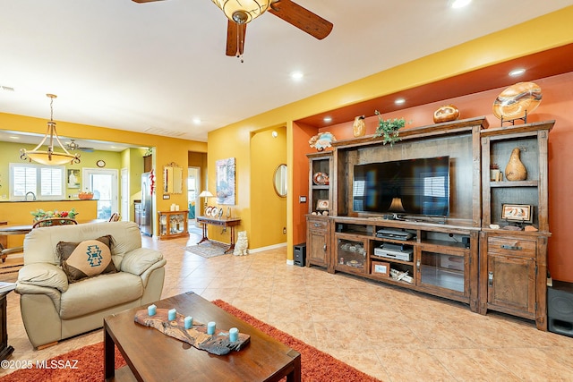 living area with visible vents, baseboards, recessed lighting, tile patterned floors, and a ceiling fan