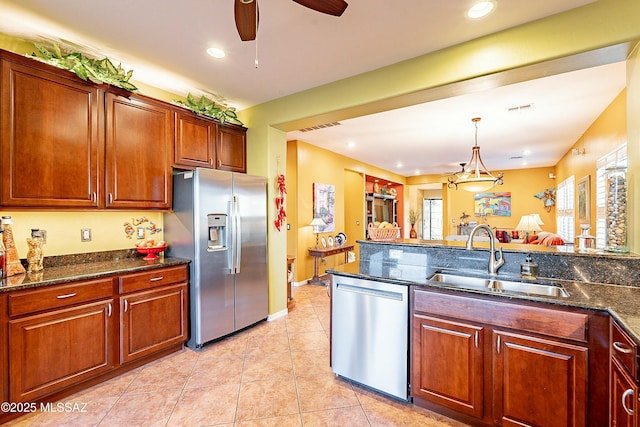 kitchen featuring a sink, stainless steel appliances, visible vents, and light tile patterned floors