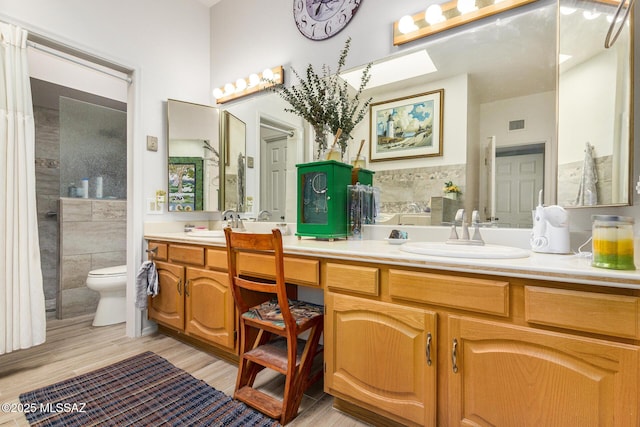 bathroom with hardwood / wood-style flooring, vanity, and toilet