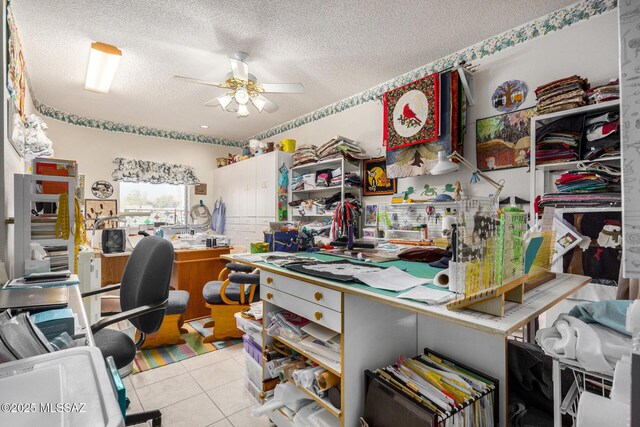 tiled office with ceiling fan and a textured ceiling