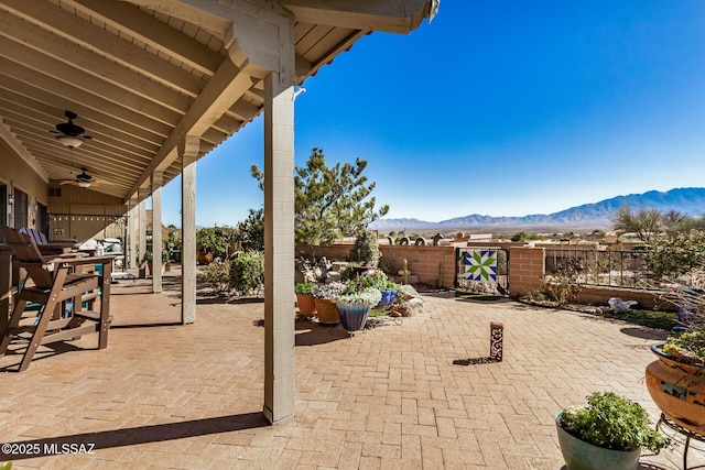 view of patio / terrace with a mountain view and ceiling fan