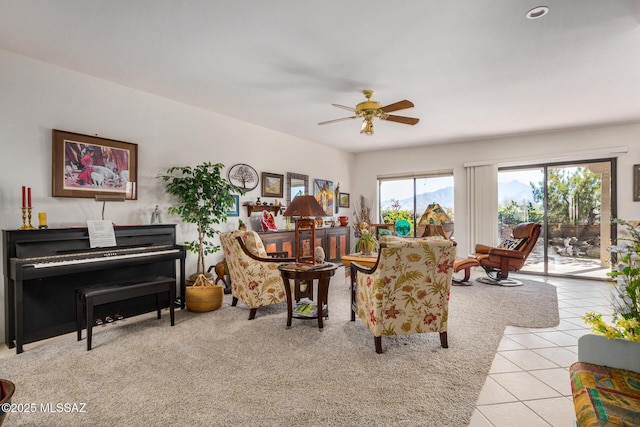 living room with ceiling fan and light tile patterned floors