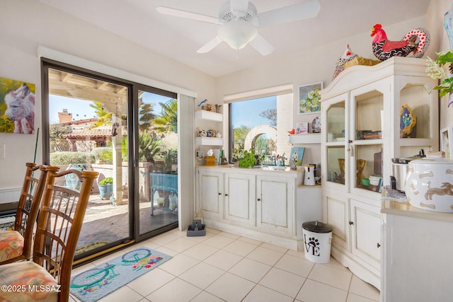 entryway featuring ceiling fan and light tile patterned floors