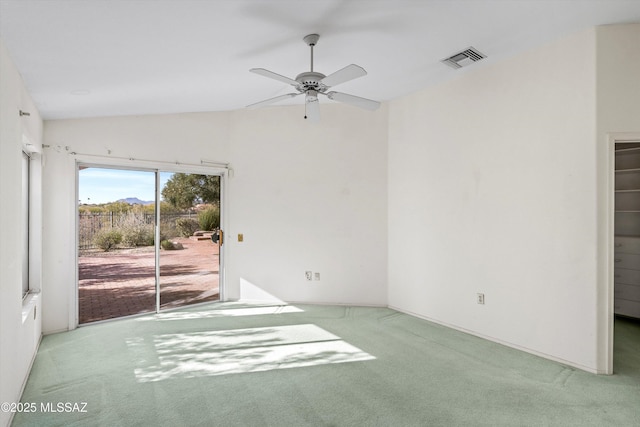 spare room featuring ceiling fan, lofted ceiling, and carpet flooring