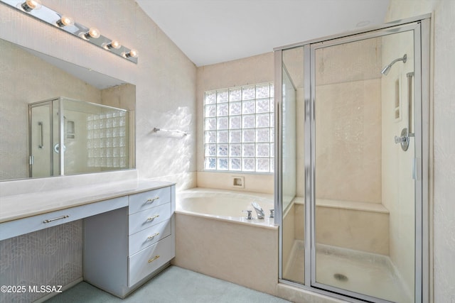 bathroom featuring vanity, lofted ceiling, and independent shower and bath