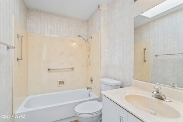 full bathroom featuring vanity, a skylight, bathtub / shower combination, and toilet