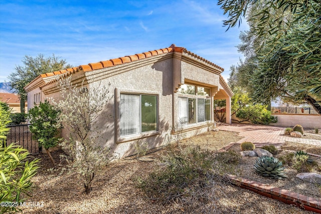 view of property exterior featuring a patio area