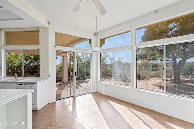 unfurnished sunroom with sink and ceiling fan