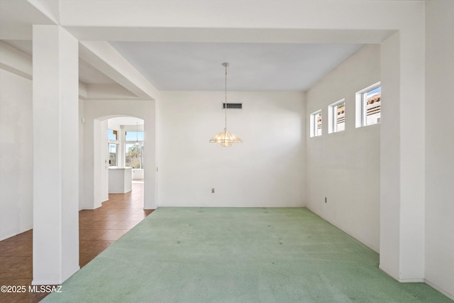 unfurnished dining area featuring carpet