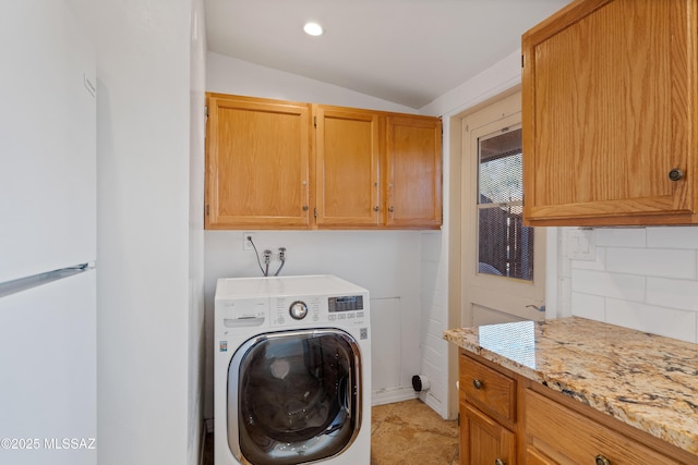 clothes washing area featuring washer / dryer and cabinets