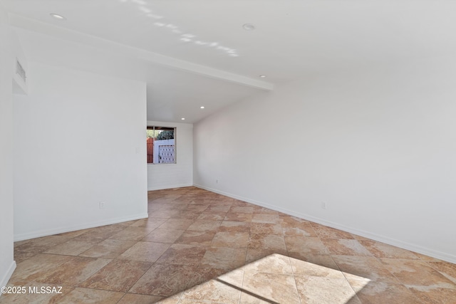 spare room with lofted ceiling with beams