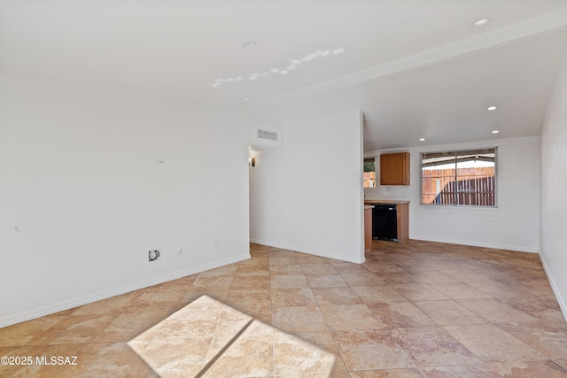 unfurnished living room with vaulted ceiling with beams