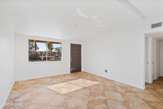 empty room with beamed ceiling