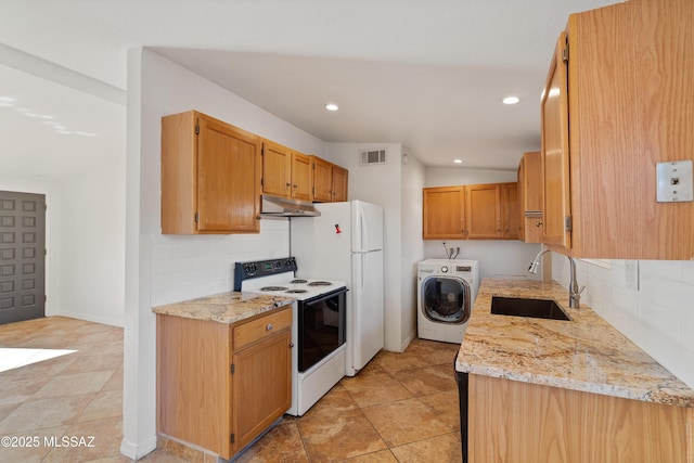 kitchen featuring sink, range with electric cooktop, washer / clothes dryer, light stone counters, and tasteful backsplash