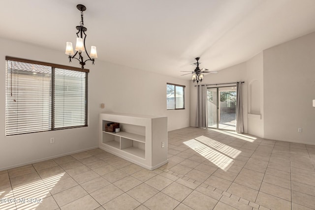 interior space with ceiling fan with notable chandelier and light tile patterned floors