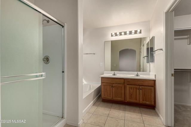 bathroom with tile patterned flooring, separate shower and tub, and vanity