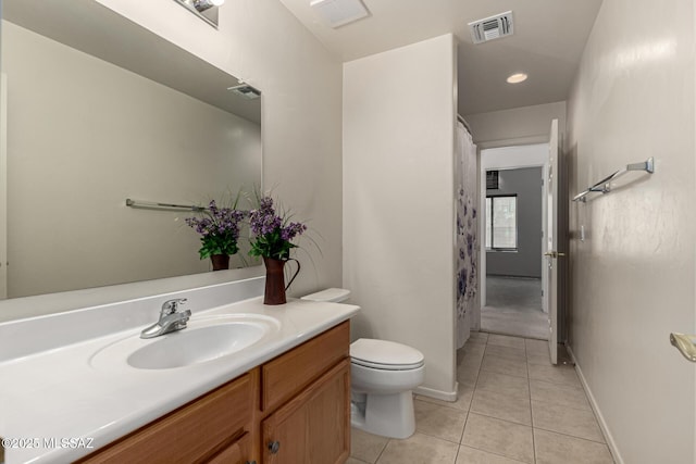 bathroom with toilet, tile patterned floors, and vanity