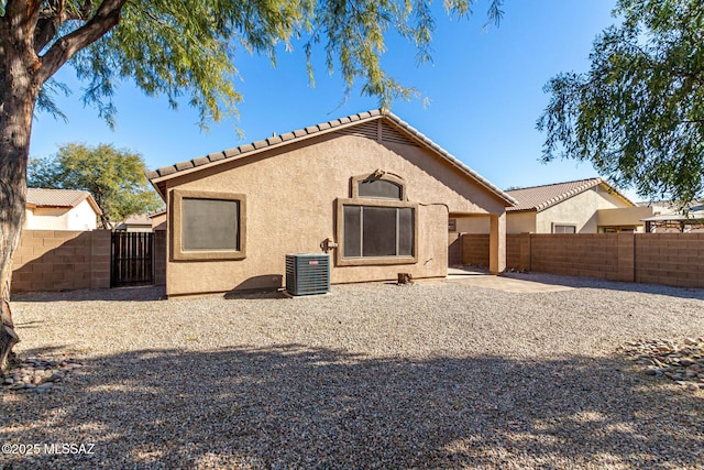 rear view of property with a patio area and central air condition unit