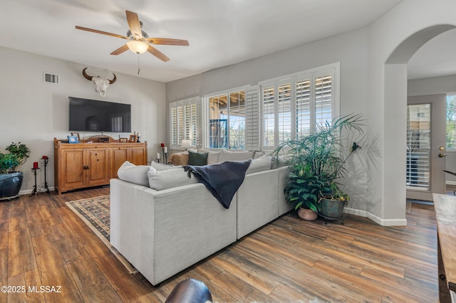 living room with ceiling fan, a healthy amount of sunlight, and dark hardwood / wood-style floors