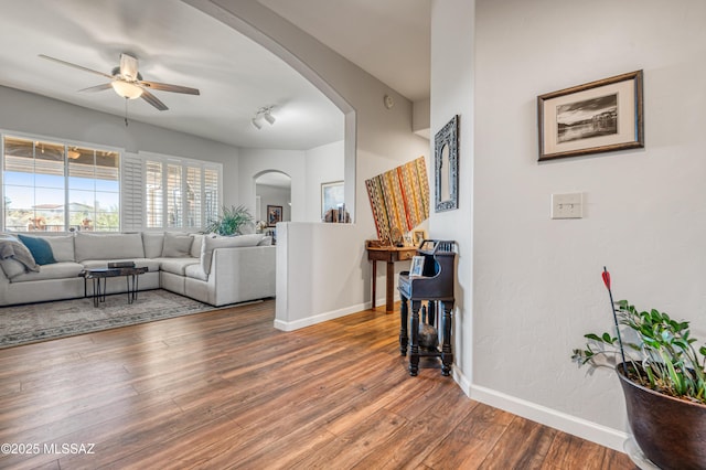 living room with ceiling fan, hardwood / wood-style floors, and track lighting