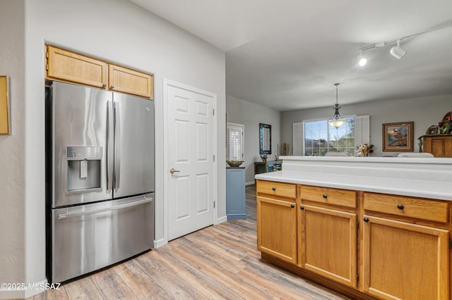 kitchen with light hardwood / wood-style flooring, stainless steel fridge, track lighting, and pendant lighting