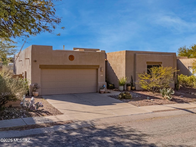 southwest-style home featuring a garage