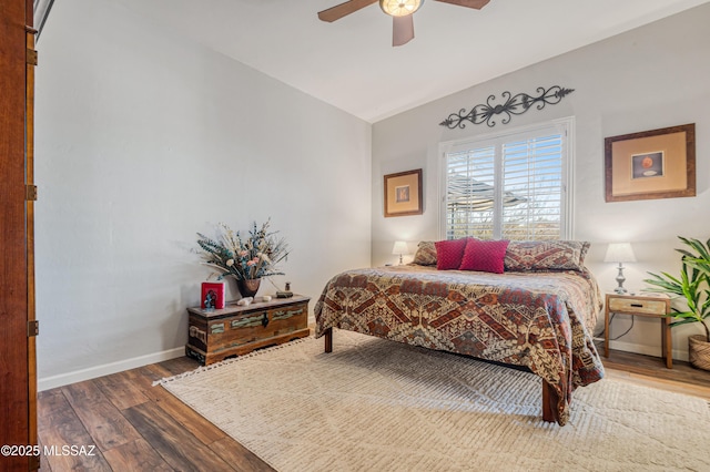 bedroom with ceiling fan, wood-type flooring, and vaulted ceiling