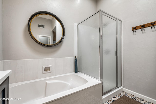 bathroom featuring vanity, independent shower and bath, and tile patterned flooring