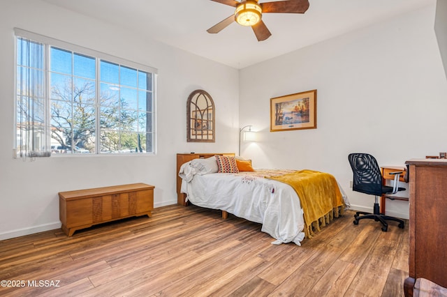 bedroom with ceiling fan and wood-type flooring