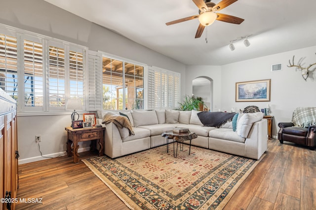 living room featuring ceiling fan, rail lighting, and hardwood / wood-style flooring