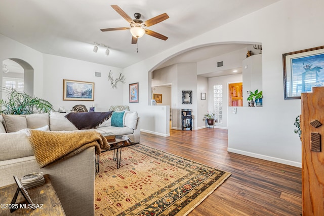 living room featuring ceiling fan and dark hardwood / wood-style flooring