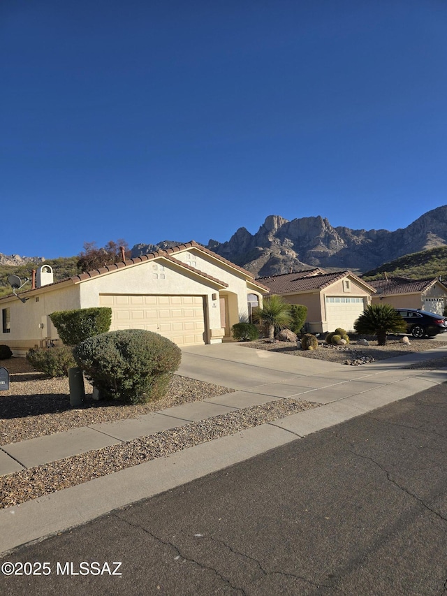 view of front of house featuring a garage and a mountain view