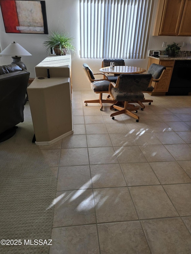 unfurnished dining area featuring light tile patterned floors