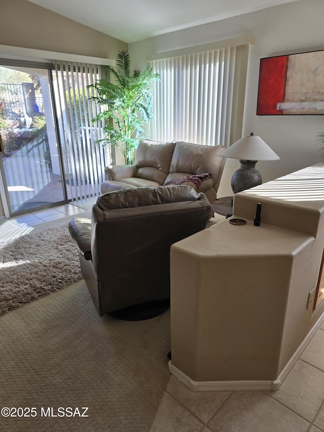 living room with light tile patterned floors and lofted ceiling