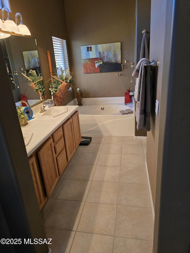 bathroom featuring a tub, tile patterned floors, and vanity