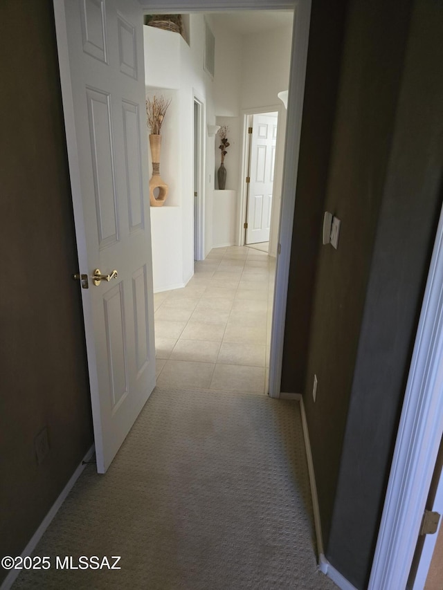 hall featuring light tile patterned flooring