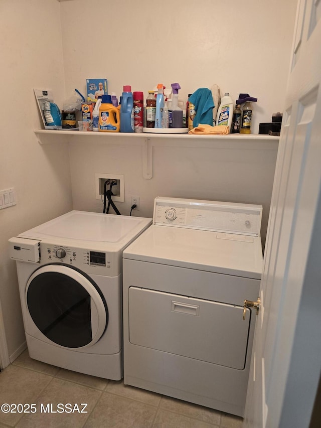 laundry room featuring light tile patterned floors and washer and clothes dryer