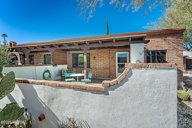 back of property with a patio