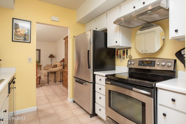 kitchen with light tile patterned flooring, appliances with stainless steel finishes, and white cabinets