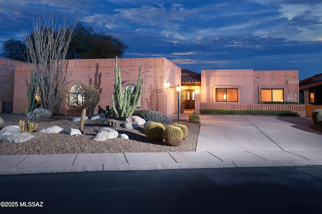 pueblo-style house featuring fence