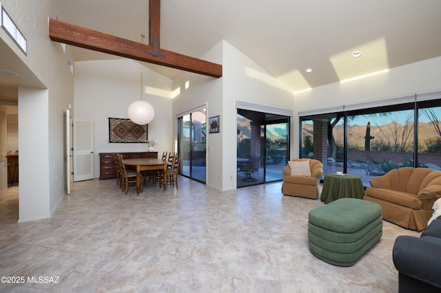 living area featuring high vaulted ceiling, beamed ceiling, and baseboards