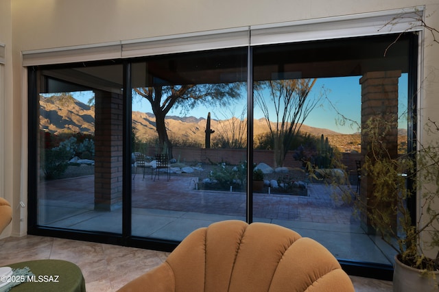 doorway to outside featuring light tile patterned flooring and a mountain view