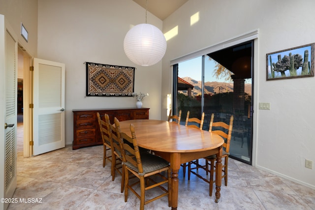 dining room with a high ceiling