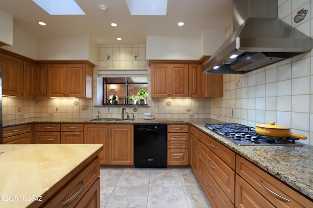 kitchen with stainless steel gas cooktop, a sink, ventilation hood, brown cabinets, and tasteful backsplash