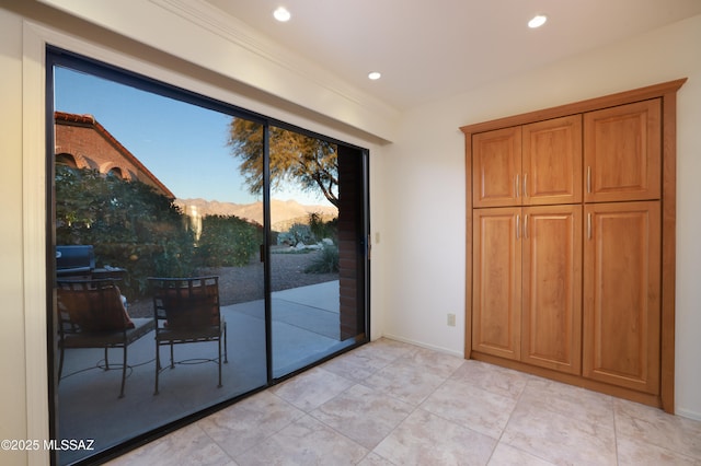 doorway to outside with baseboards, crown molding, and recessed lighting